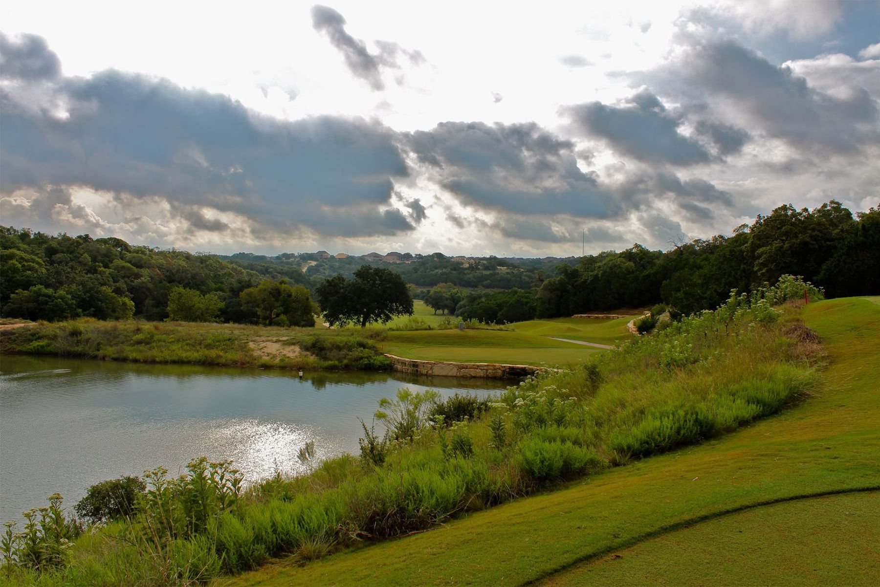 Hill Country view over the golf course pond at Crystal Falls in Leander