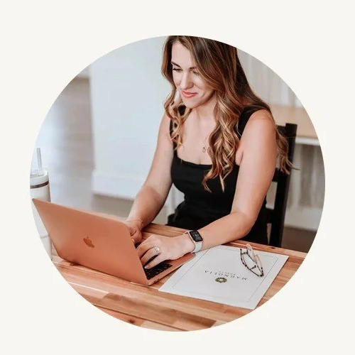 Sarah reviewing a listing on a laptop